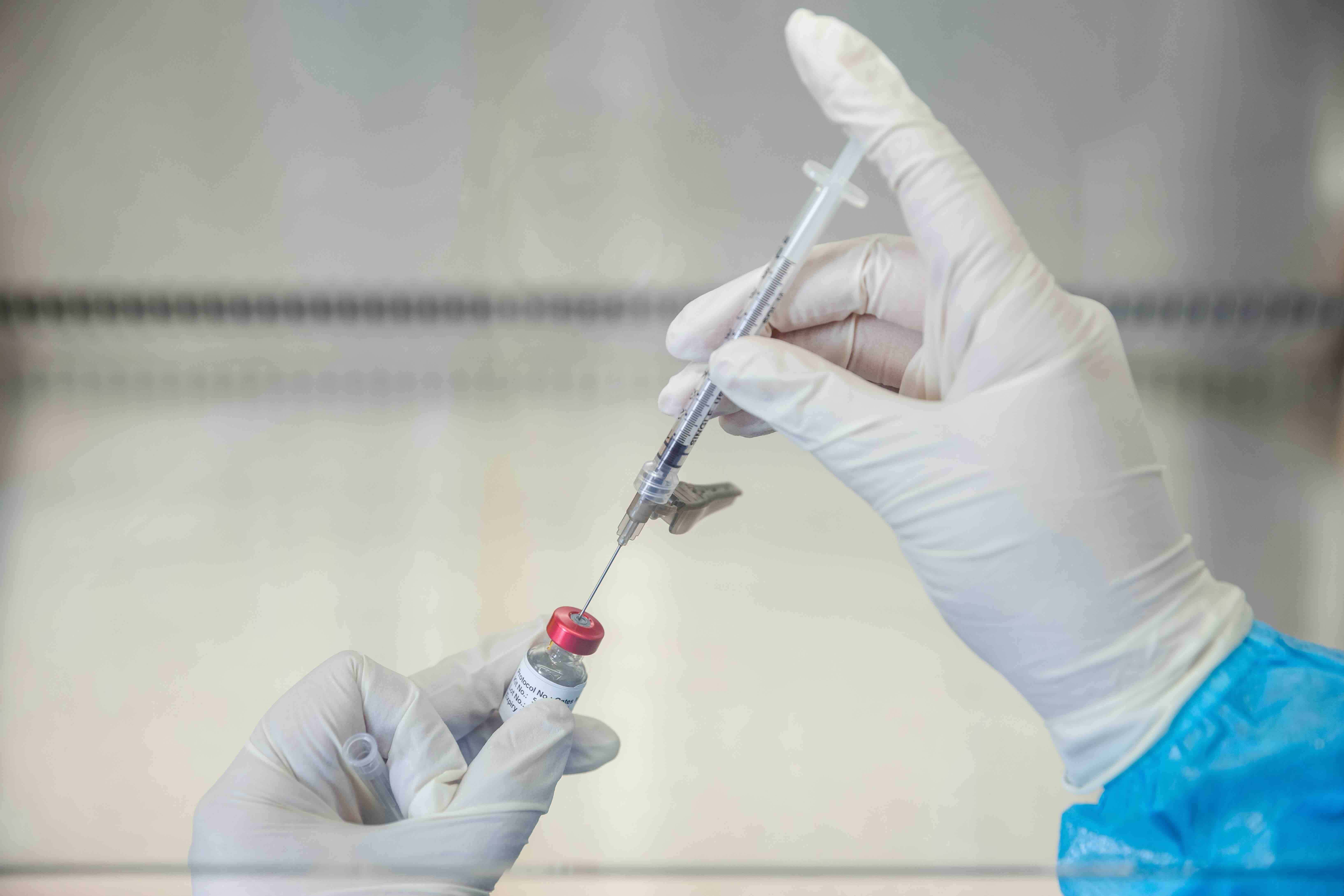 Image of hands holding a vaccine